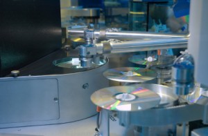 machine making silver cds discs in a factory