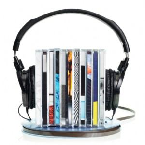 pile of cds the Hi-Fi headphones on standing on a vintage reel of audio tape