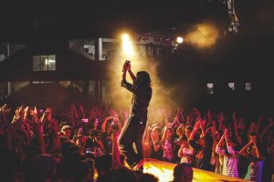 singer clapping on stage , audience clapping happy muic gig