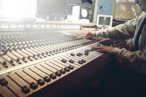 music mixing desk operated by a man