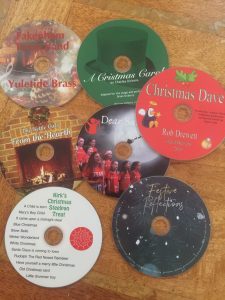 cds on a table varoius christmas prints all festive