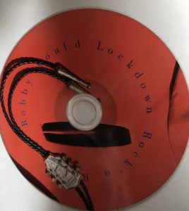 red cd with lockdown sessions printed and picture of electrical leads