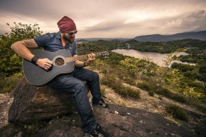 mountains lakes man playing guitar