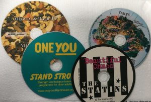 4 colourful cds one says " stand strong"